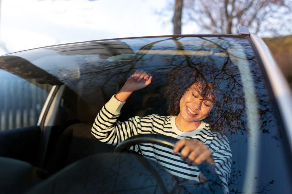 A girl enjoying in the car