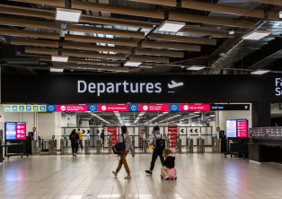 Departures hall at London Luton Airport with passengers - luton Airport Taxi drop-off