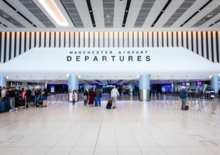 Manchester Airport Departures check‑in area with passengers – book Manchester Airport Tax