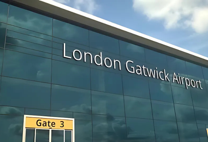 London Gatwick Airport exterior with large sign. Getwick Airport Taxi transfers