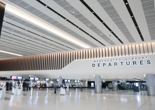 Manchester Airport Departures hall with check‑in counters – Manchester Airport Taxi drop‑off