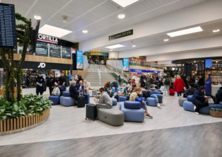 Busy departures lounge at London Gatwick Airport with seating