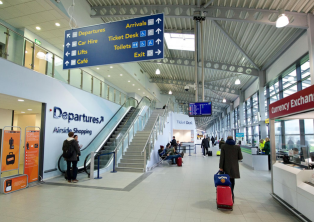 Departures hall with signage at London Southend – Southend Airport Taxi